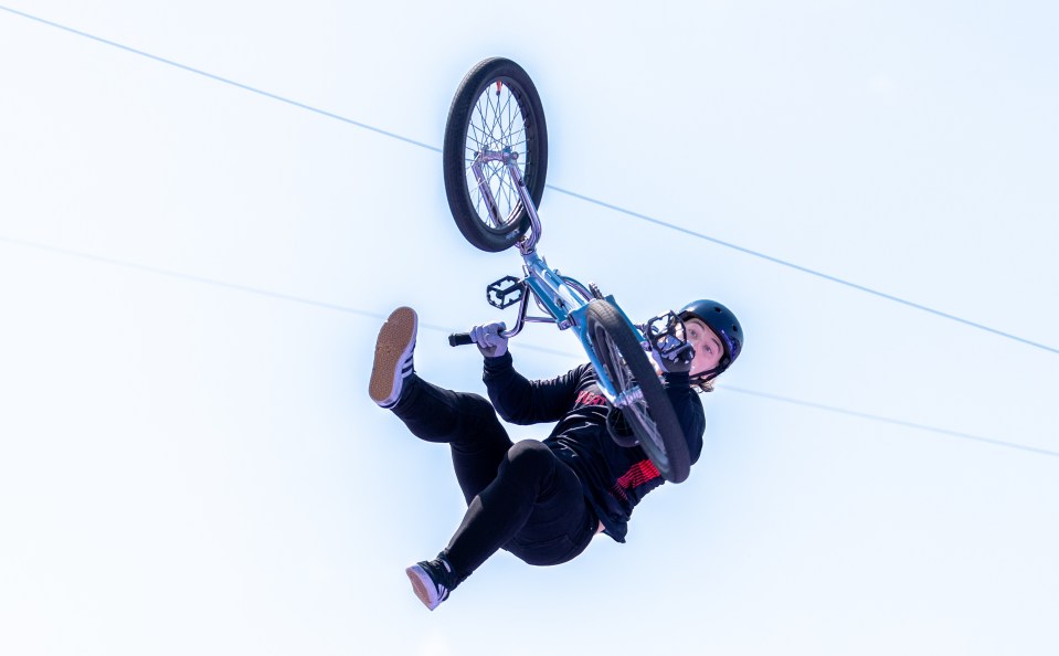 a person is doing a trick on a bike with a shirt that says ' new york ' on it