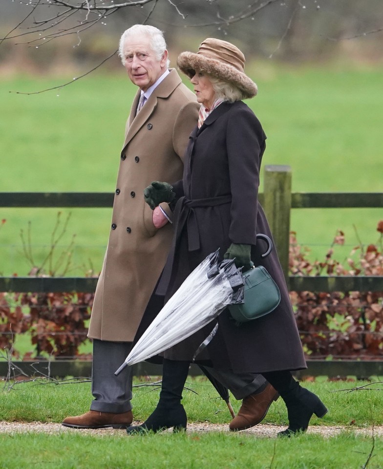 a man and a woman walking down a path with an umbrella