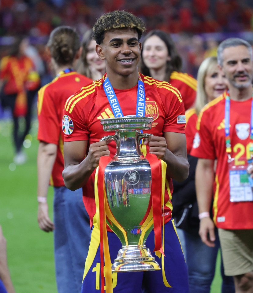 a man holding a trophy that says uefa euro on it