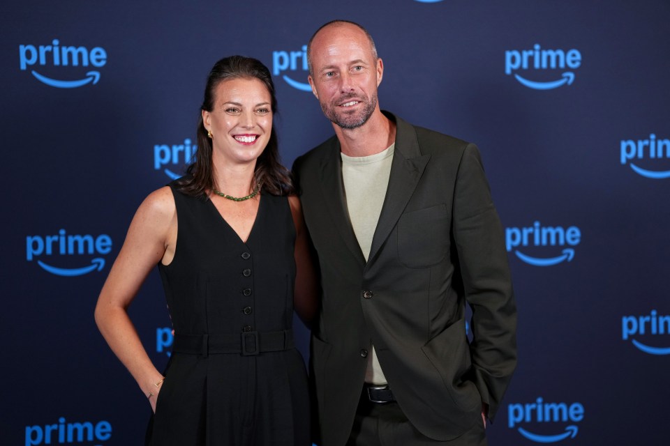 a man and a woman pose for a picture in front of a wall that says prime