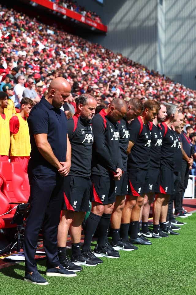 a group of men standing on a field with aa on their shirts