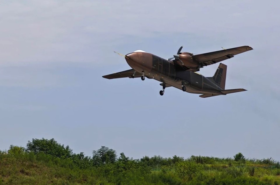 a small brown airplane with the letters nc on the tail