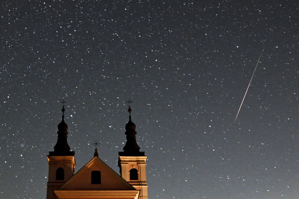 A meteor crossing the night sky over the Post-Camaldolese monastery in the village of Wigry, Poland, during the annual Perseids meteor shower on August 12, 2024