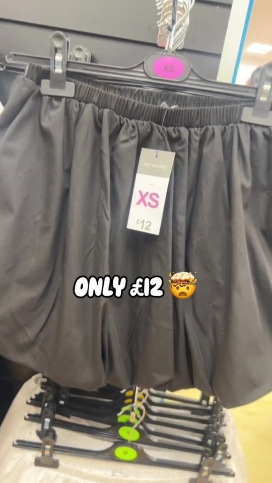 a black skirt with a tag that says xs on it