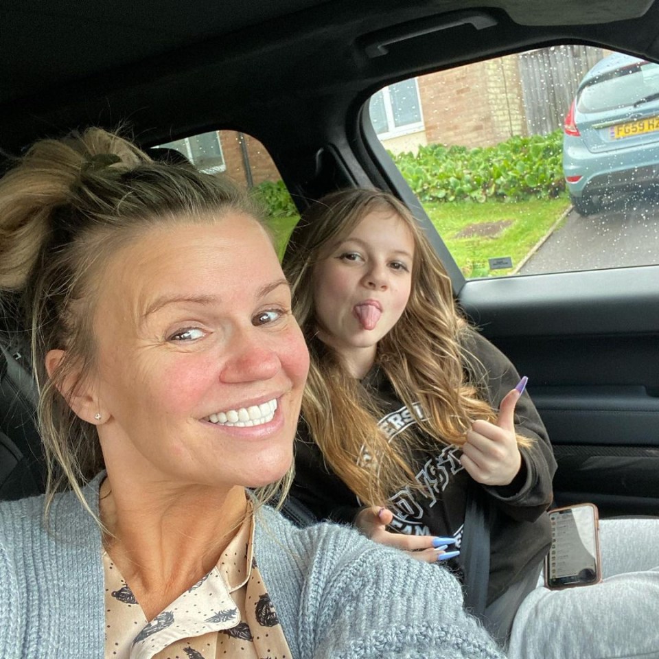 a woman and a girl in a car with the girl sticking her tongue out