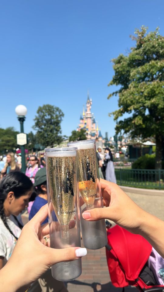 Luana Alonso standing by the famous Disney Castle in Paris