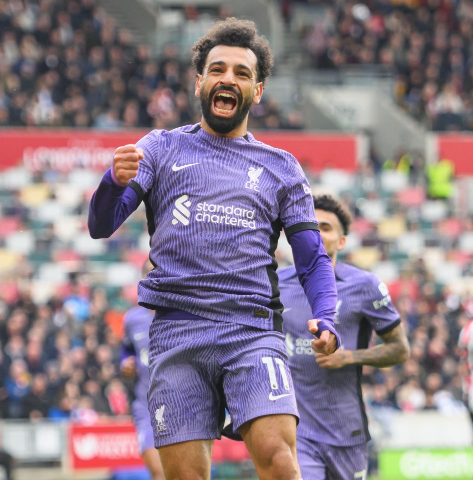 a soccer player wearing a purple jersey that says standard chartered