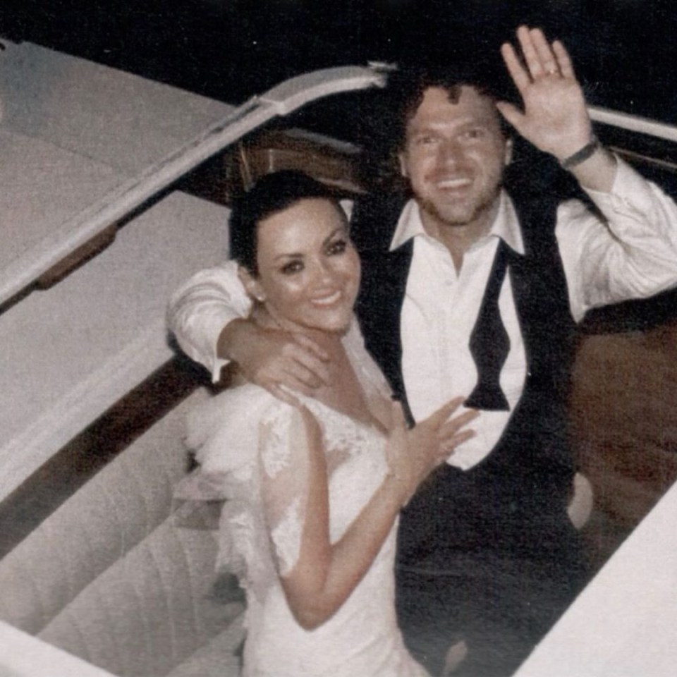 a man in a tuxedo and a woman in a wedding dress pose for a photo