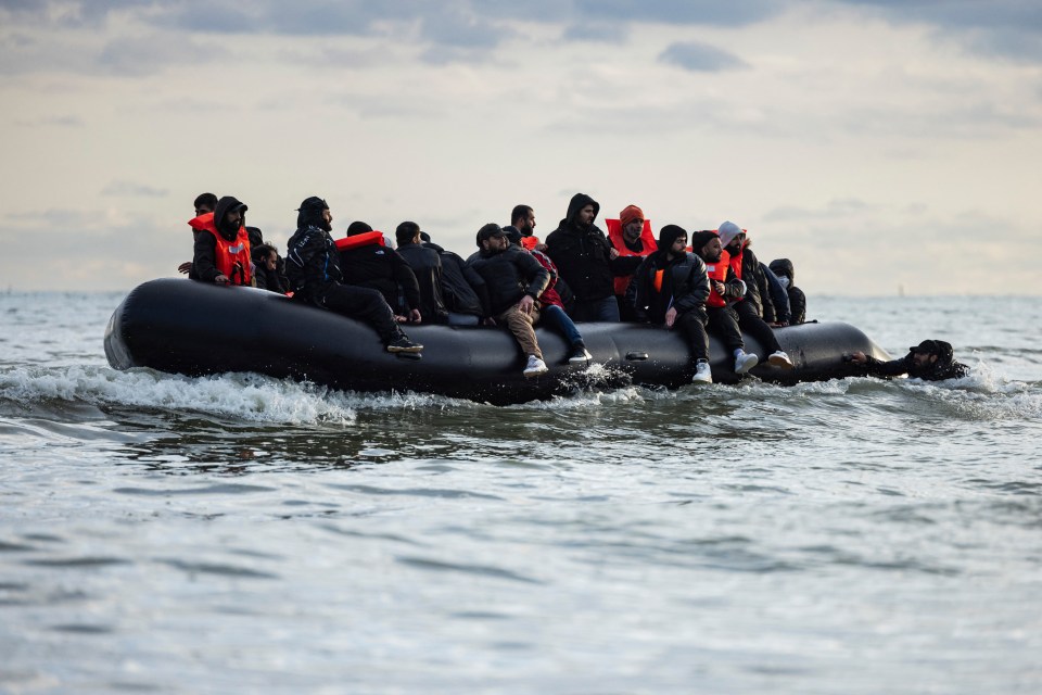 a group of people are in a raft in the ocean