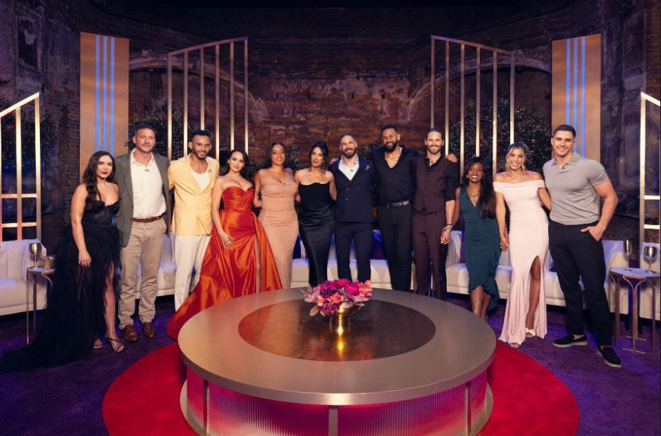 a group of people posing for a picture in front of a round table