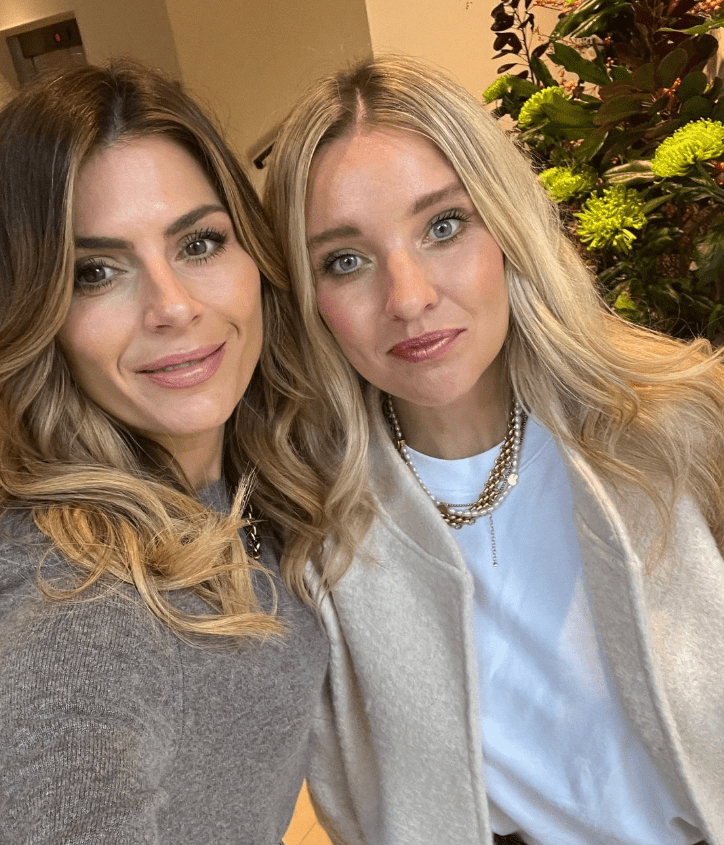 two women posing for a picture with one wearing a white shirt