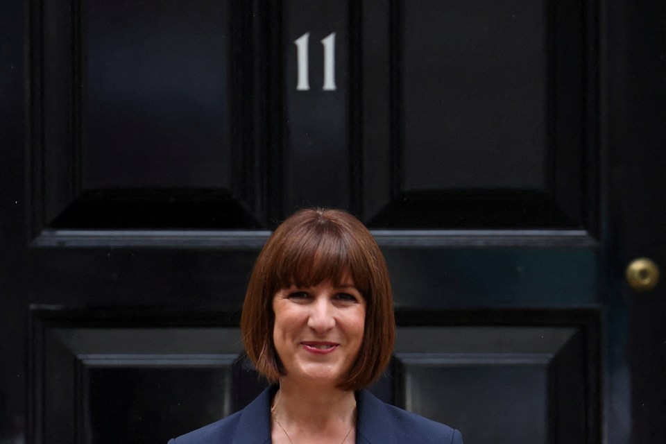 a woman stands in front of a black door with the number 11 on it