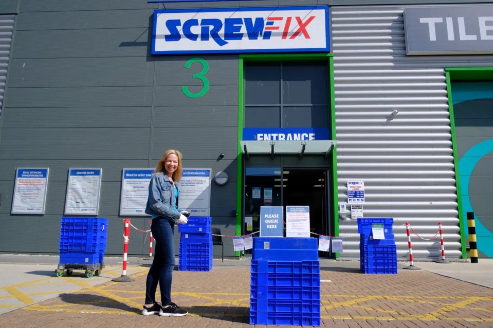 a woman stands in front of a screwfix store