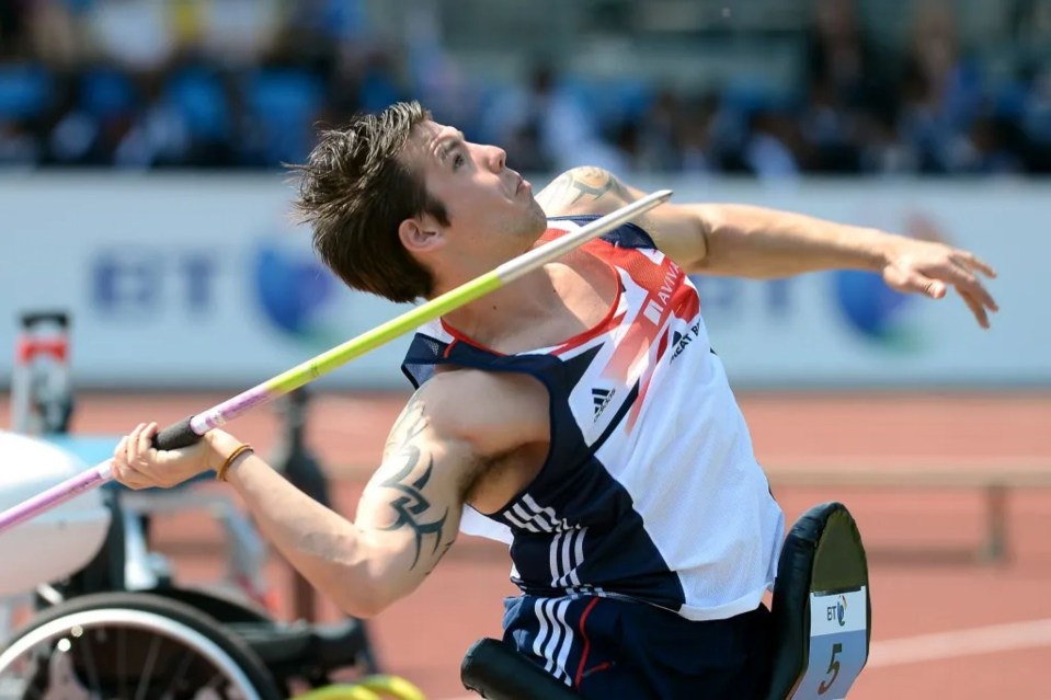 a man in a wheelchair is throwing a javelin