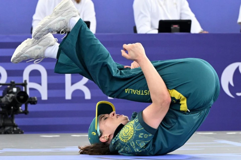 a man is doing a handstand in front of a sign that says australia