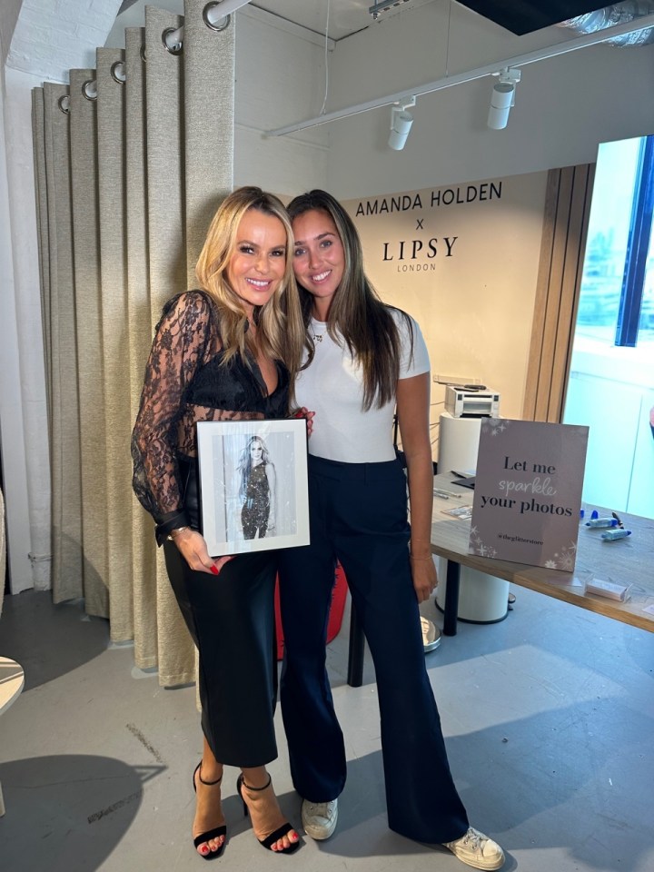 two women standing in front of a sign that says amanda holden x lipsy