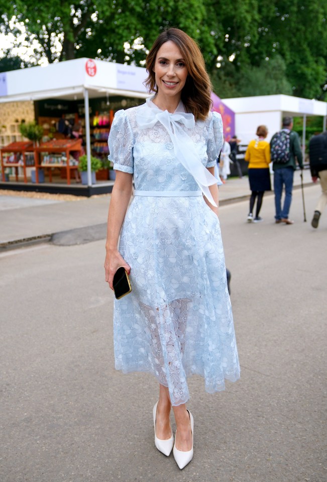 a woman wearing a light blue lace dress and white heels