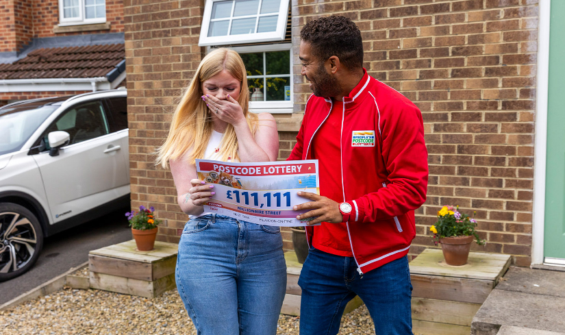 She can't believe the amount on the cheque presented by Danyl Johnson