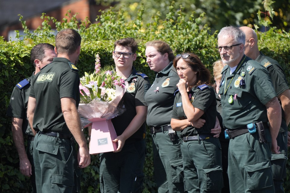 Paramedics outside the church showing their support