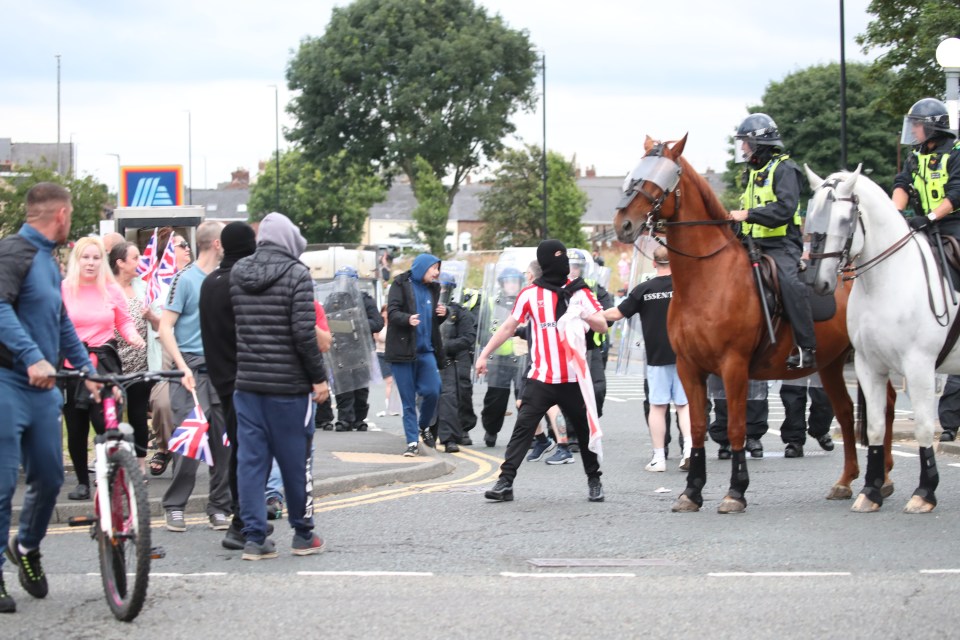 Rioters were pictured clashing with cops in Sunderland city centre earlier on Friday