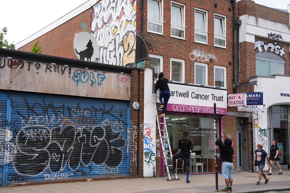 a brick building with a sign that says artwell cancer trust