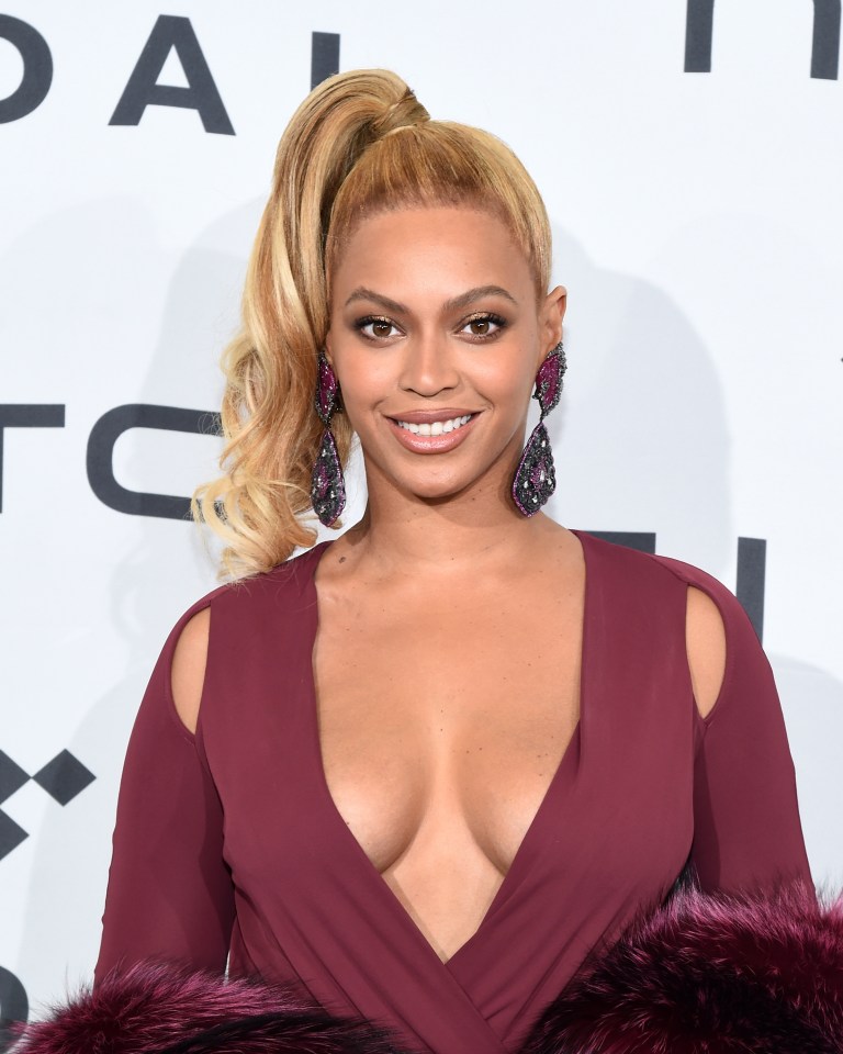 a woman with a ponytail is wearing a plunging red dress