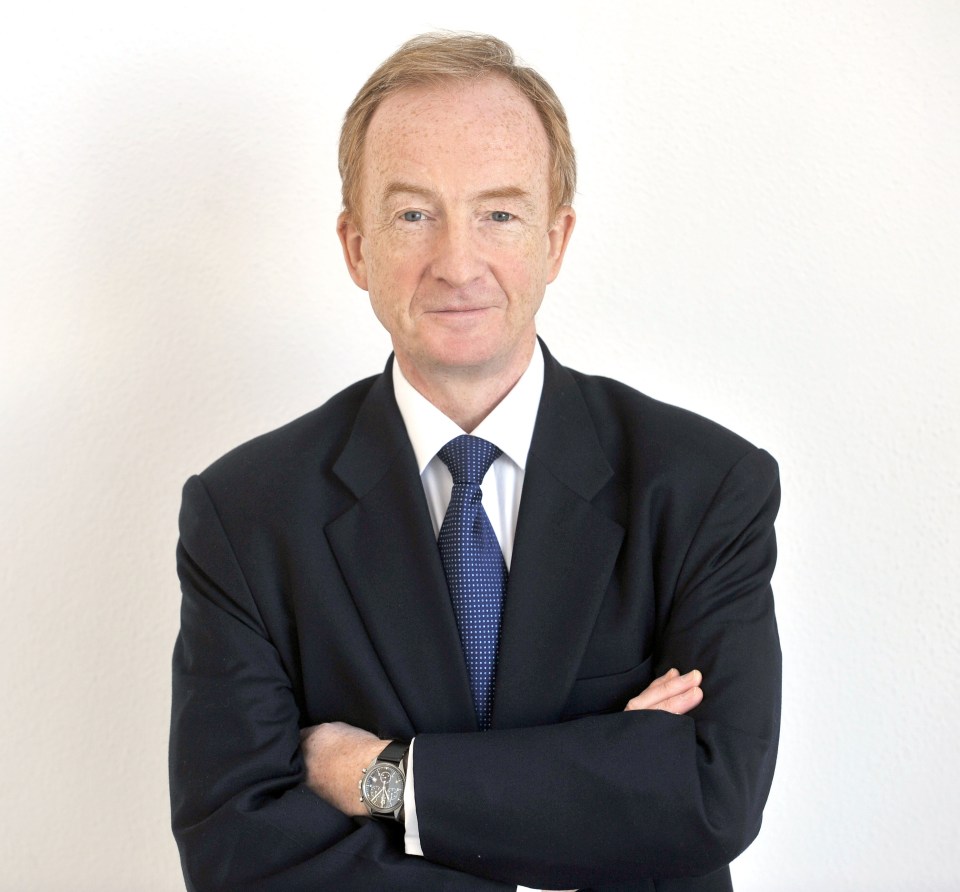 a man in a suit and tie with his arms crossed