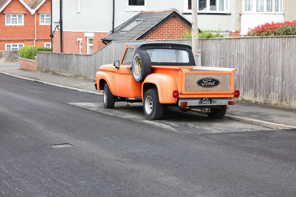 The car is now in a dilapidated state with rubbish deposited on and around it