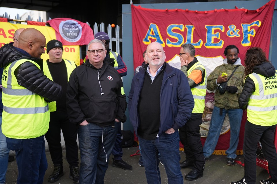 a group of people standing in front of a banner that says ' asleep ' on it