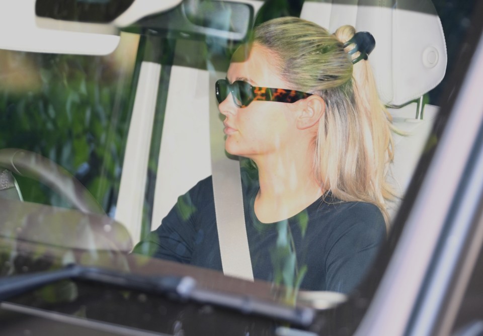 a woman wearing sunglasses is sitting in a car