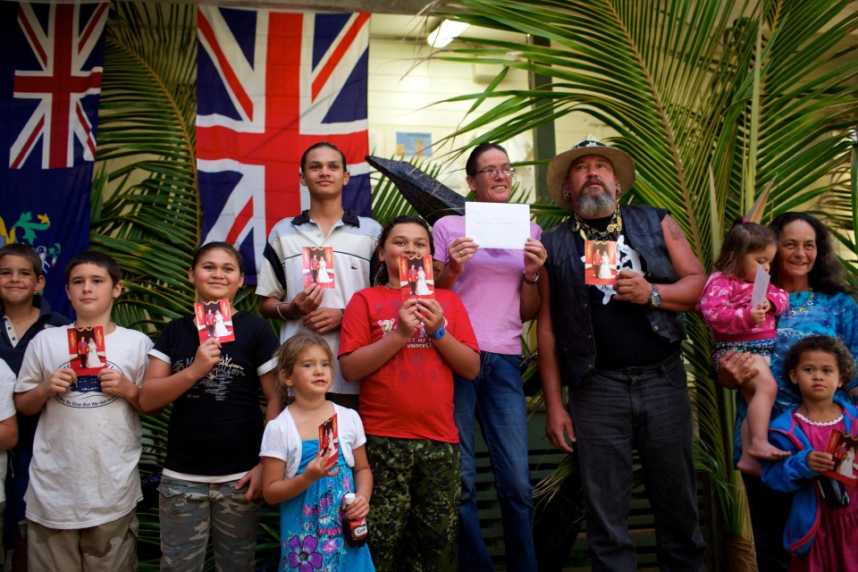 a group of people standing in front of a british flag