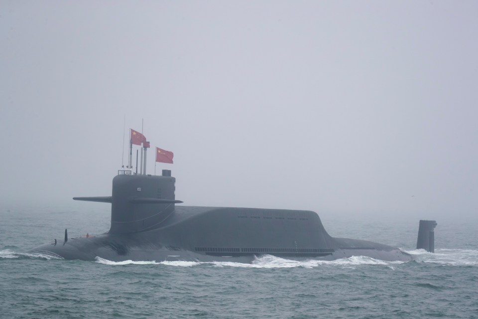 a submarine with chinese flags on top of it