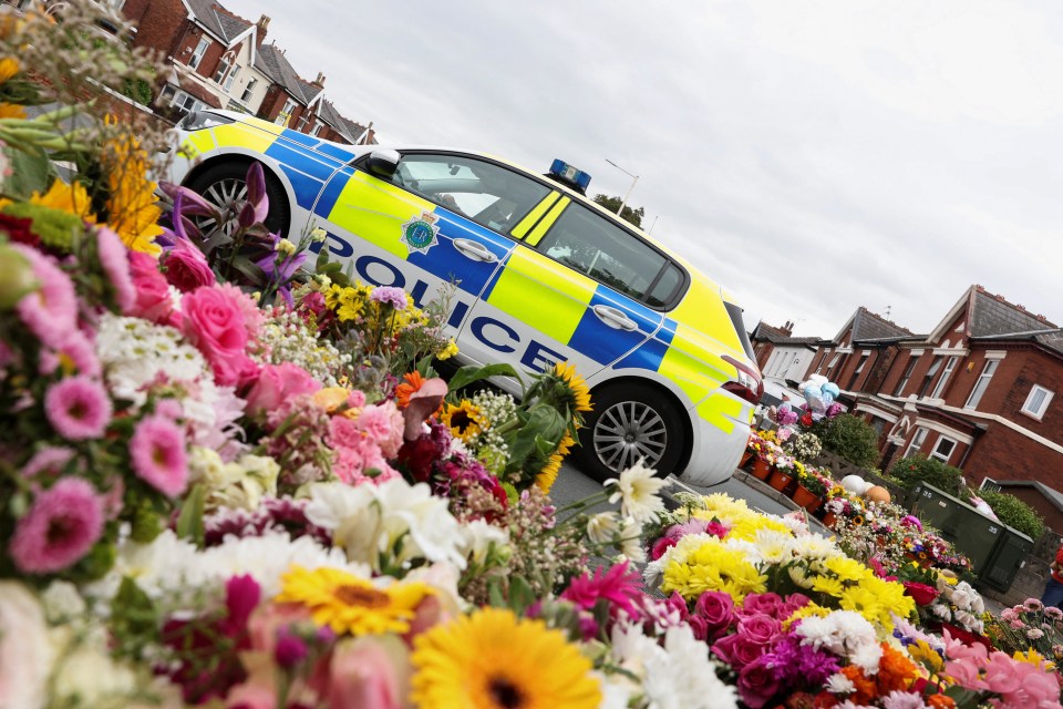 A police car sits parked near the site