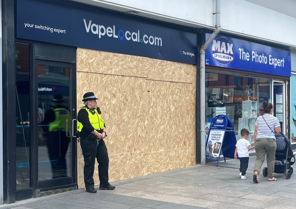 Prosecutors added the rioting charge after reviewing evidence from the day, in which violent yobs looted a vape shop, above