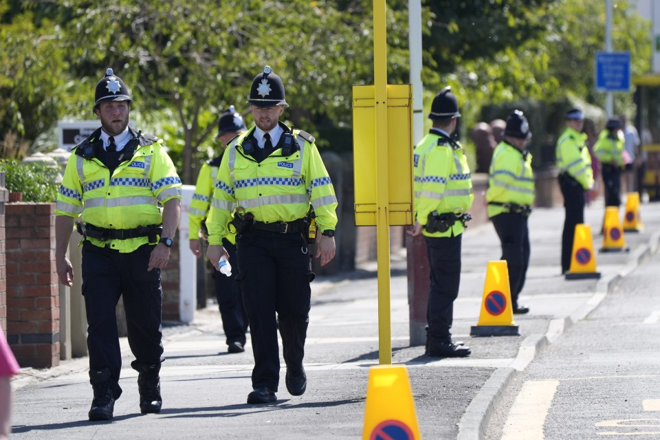 a group of police officers are walking down a street