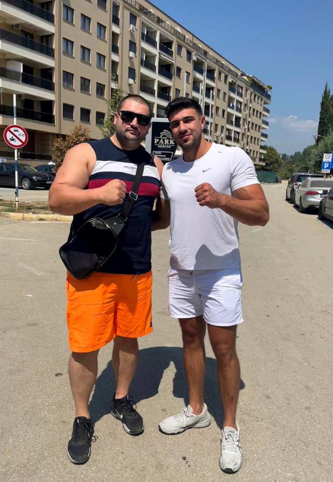 Tommy, 25, flashed his biceps as he stood alongside a fan in the Macedonia sunshine