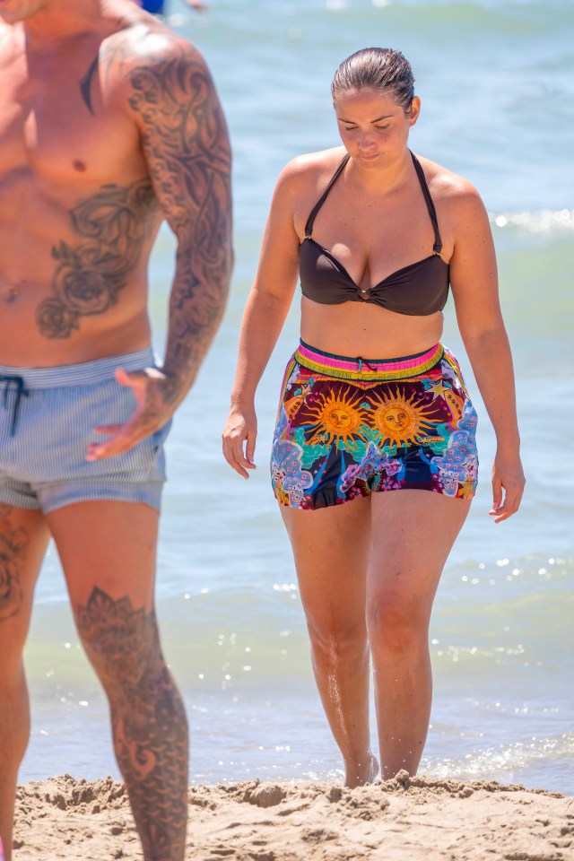 The actress slipped into a black bikini top during a stroll on the beach