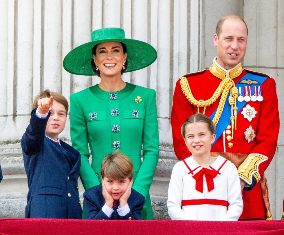 a family posing for a picture with one child pointing at the camera