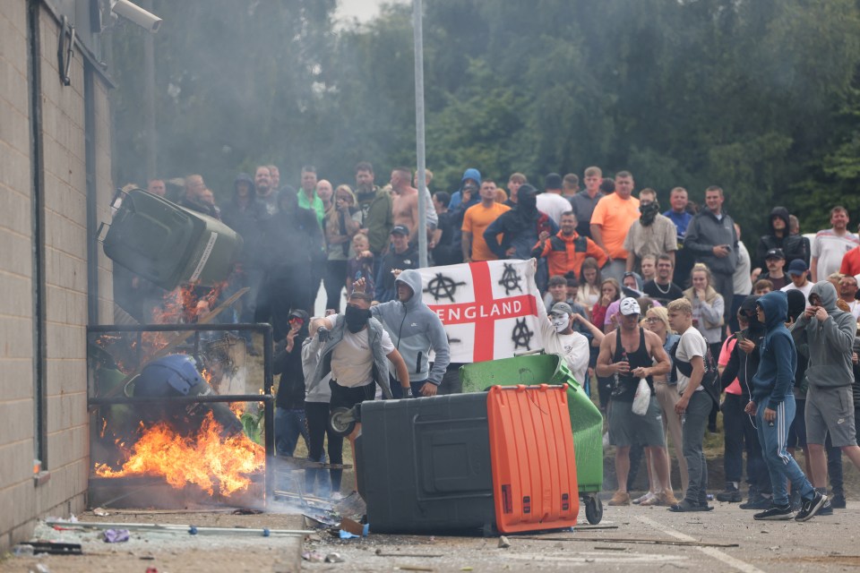 a group of people holding a flag that says england