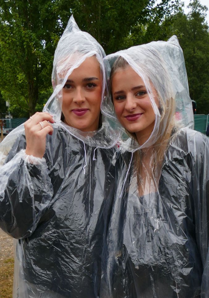 Music fans do the best they can to keep dry at the Reading Festival