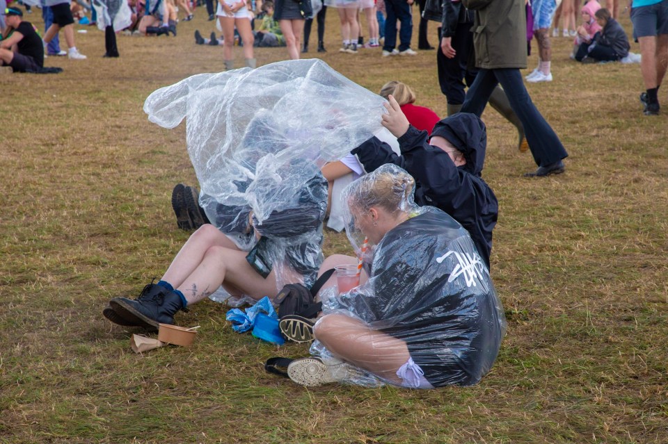 Reading revellers huddled under their water proof ponchos