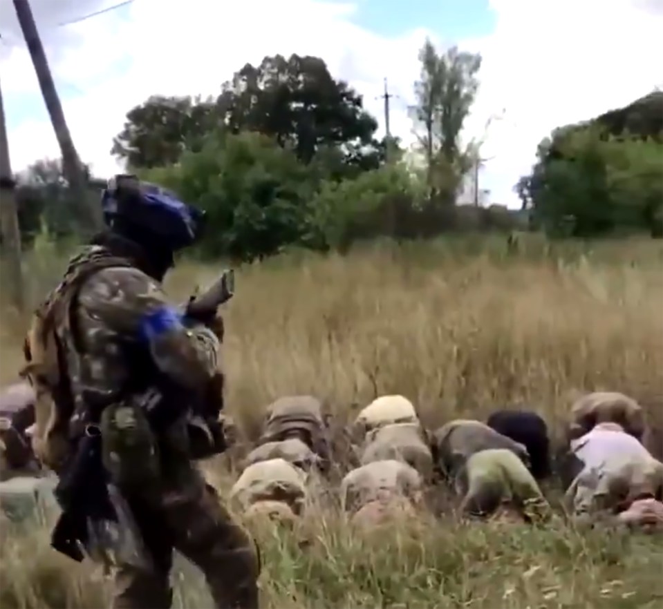 a group of soldiers are kneeling down in a field