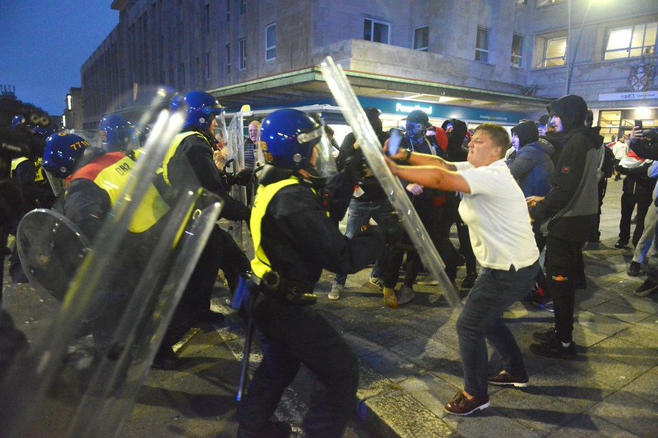 a group of police officers are standing in front of a building that says people 's bank