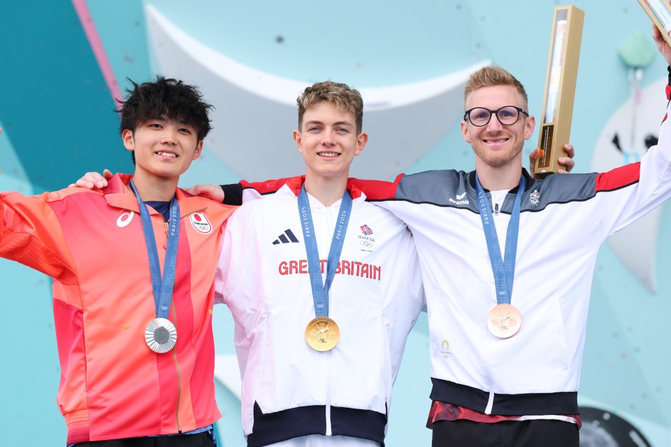 three men are posing for a picture with medals around their necks including one that says great britain