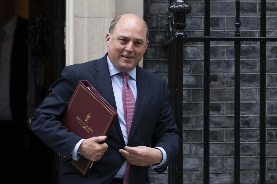 a man in a suit and tie is holding a folder that says ' secretary of state ' on it