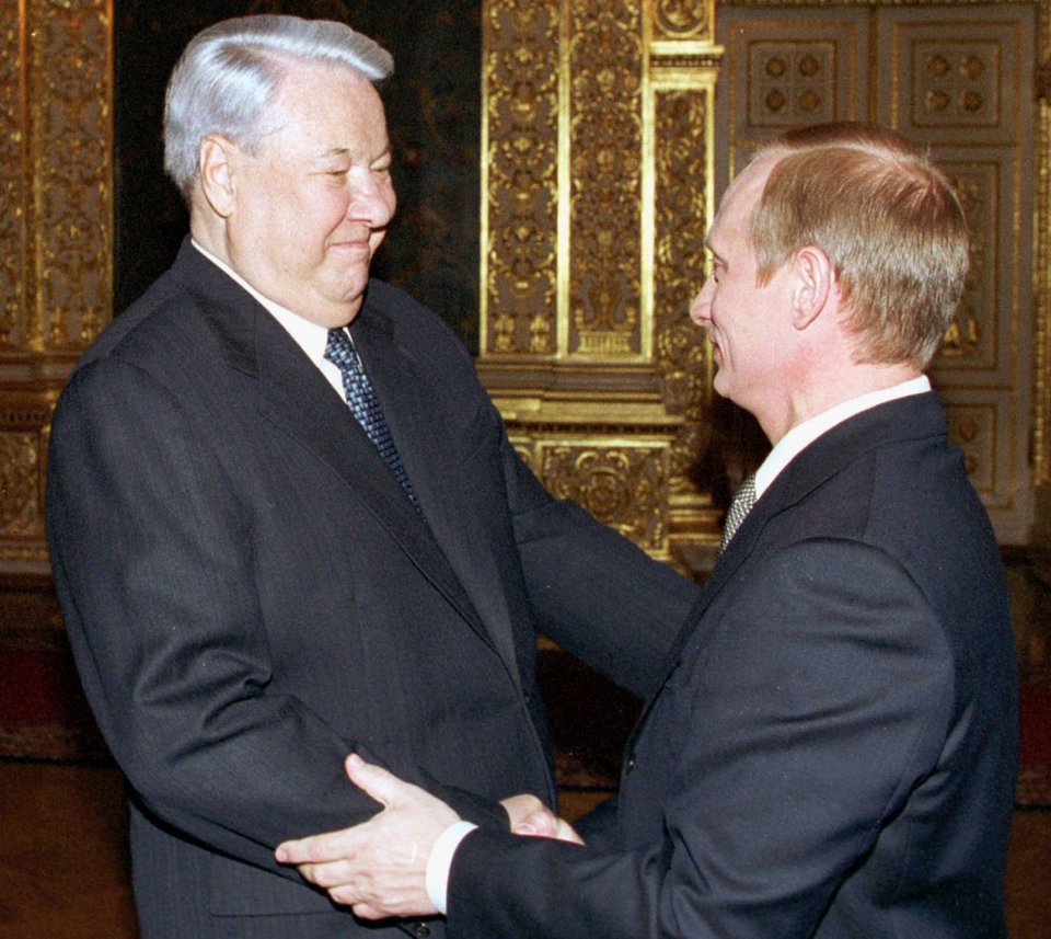 Former Russian leader Boris Yeltsin shakes hands with President Vladimir Putin after the inauguration ceremony in the Kremlin