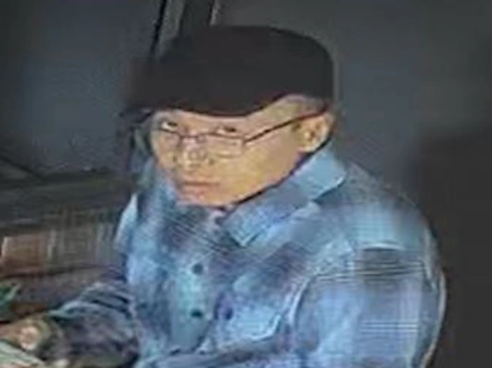 He's seen on CCTV wearing a black hat, glasses, a blue checkered button-up shirt and shorts