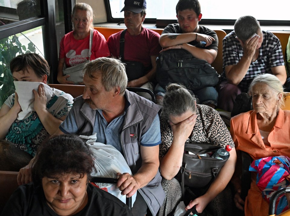 Anxious-looking Russians after they were forced to evacuate Kursk