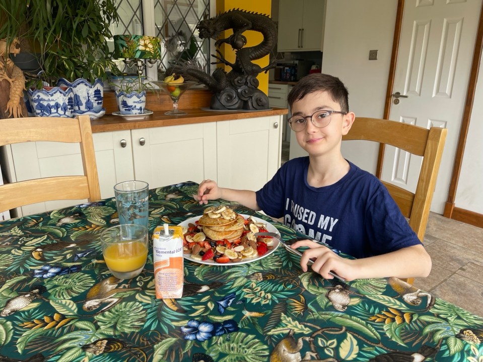 The young lad eats two breakfasts each day