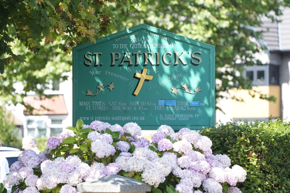 a green sign for st. patrick 's is surrounded by pink flowers